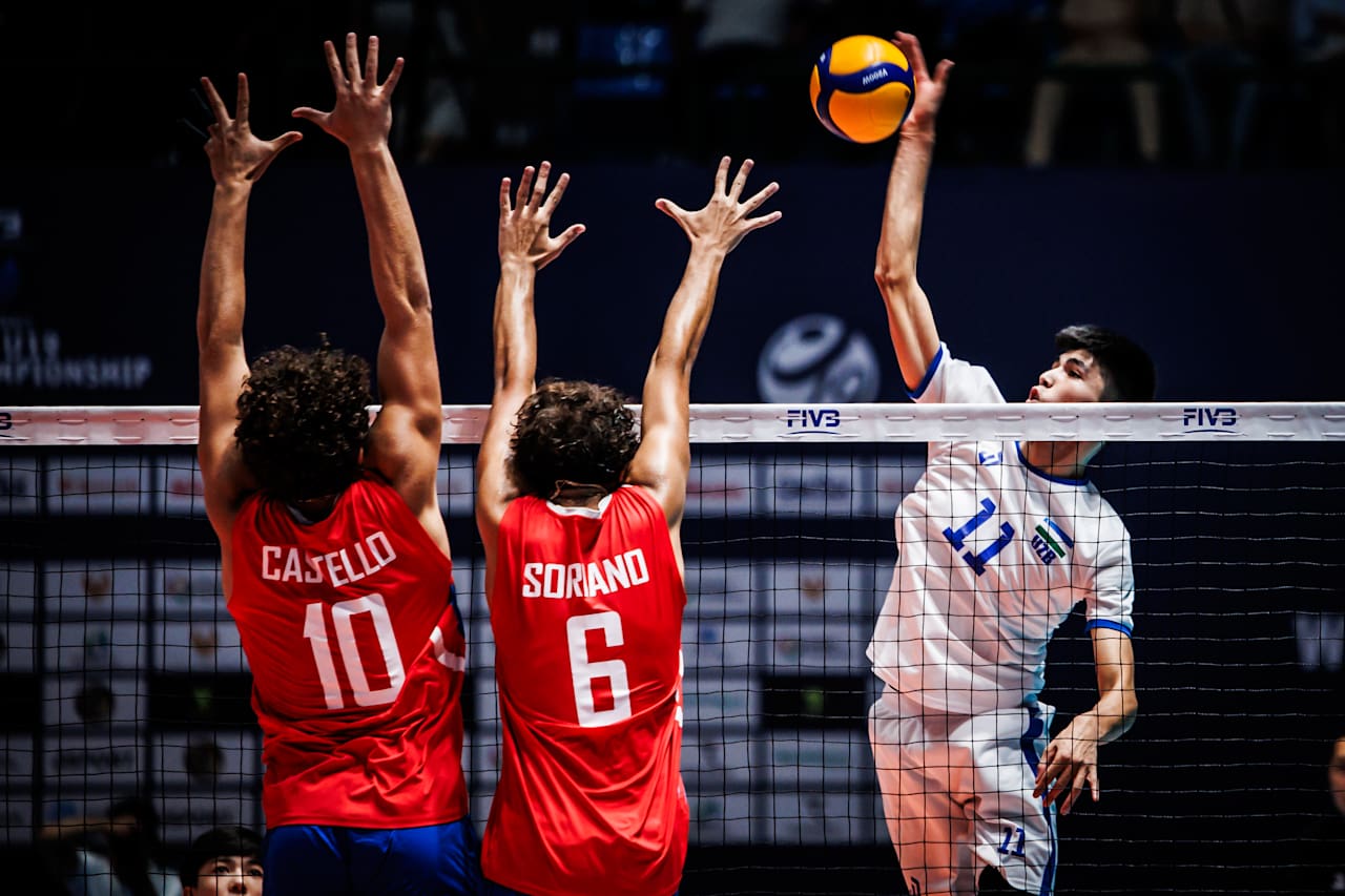 Elmurod Mamadaliyev of Uzbekistan tries to get past 2 Puerto Rican blockers